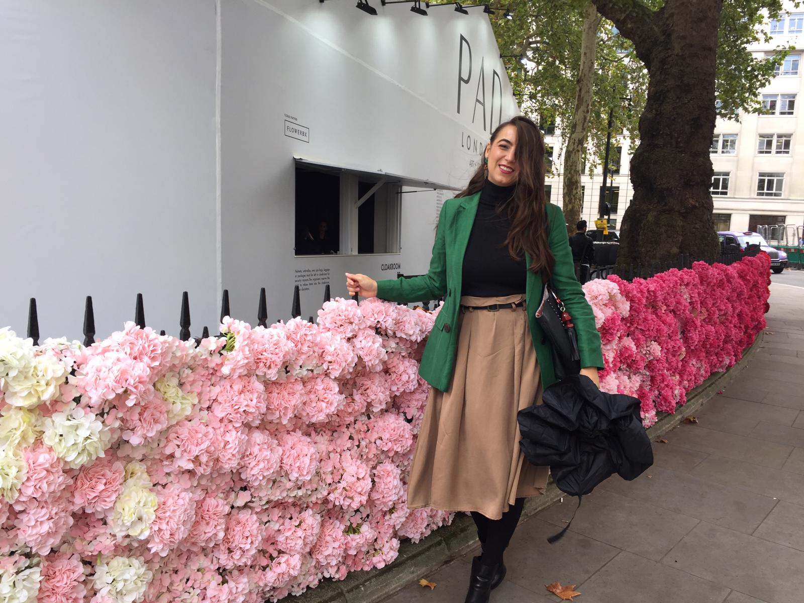 Monica in London beside a floral installation